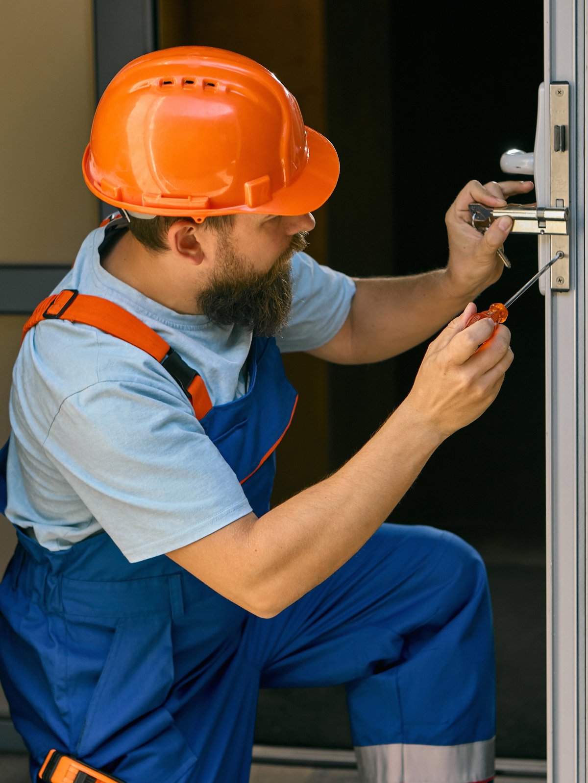 Locksmith repairing door handle at home